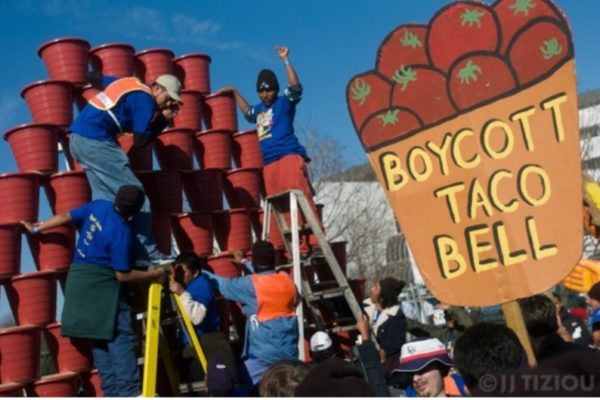 Workers from Immokalee build a pyramid of picking buckets outside Taco Bell parent company Yum Brands’ corporate headquarters in Louisville, Kentucky, in 2003. Photo courtesy of CIW.